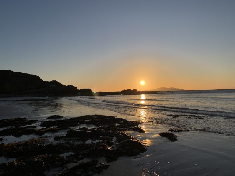 sunset over Holyhead Mountain from Church Bay beach